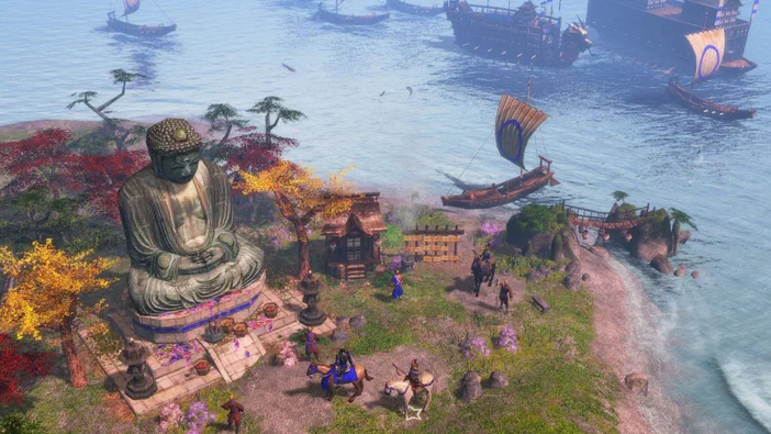 Capture d'écran de Age of Empires III montrant un port animé avec plusieurs navires en mer, une imposante statue assise sur la rive et divers personnages à pied ou à cheval près du rivage.