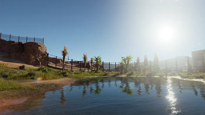 Une étendue d'eau calme reflète des palmiers et un ciel bleu sous le soleil brillant dans ce décor de jeu vidéo avec des rochers à gauche.