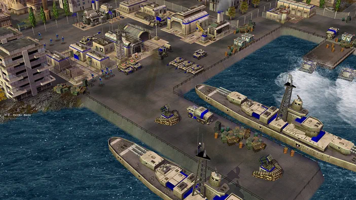 Base navale du jeu Command & Conquer Generals Zero Hour montrant des bâtiments, chars et deux grands navires amarrés à un quai.