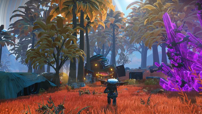 Un petit robot ou véhicule se tient au centre d'un paysage alien aux herbes rouges et arbres à feuilles dorées, près d'une formation de cristaux violets.