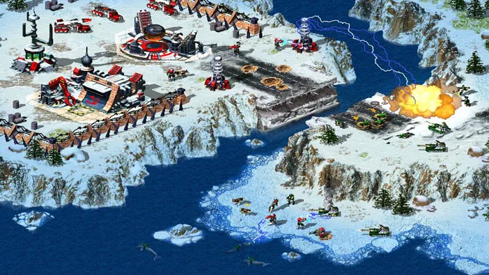 Capture d'écran de Command & Conquer : Red Alert 2 et Yuri's Revenge montrant une base militaire soviétique en hiver avec des véhicules, des soldats et une explosion.