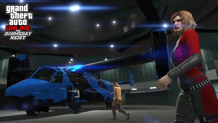 Capture d'écran de Grand Theft Auto V Legacy montrant un hélicoptère bleu dans un hangar avec deux personnages humains.