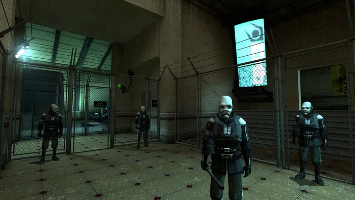 Capture d'écran de Half-Life 2 montrant un personnage en combinaison et masque dans une salle industrielle avec des barbelés.