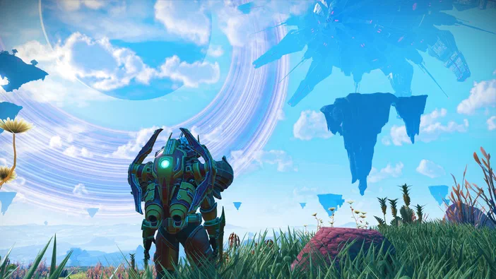 Capture d'écran du jeu vidéo No Man's Sky montrant un personnage en armure futuriste se tenant dans un champ herbeux parsemé de plantes et de rochers flottants, le tout sous un vaste ciel bleu clair orné de nuages blancs.