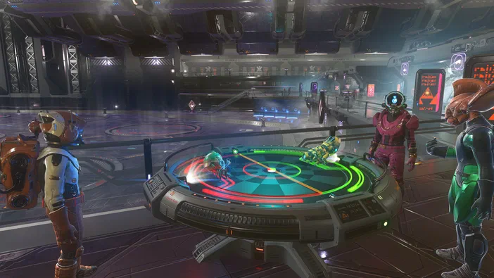 Capture d'écran montrant plusieurs personnages aliens entourés d'une table holographique lumineuse au centre, dans une base spatiale futuriste avec des structures métalliques.