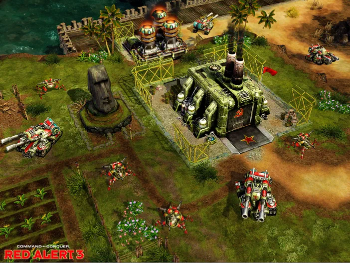 Capture d'écran du jeu vidéo Command & Conquer Red Alert 3 montrant une base militaire soviétique avec des chars et soldats mécanisés, ainsi qu'une statue Moaï dans un paysage verdoyant.