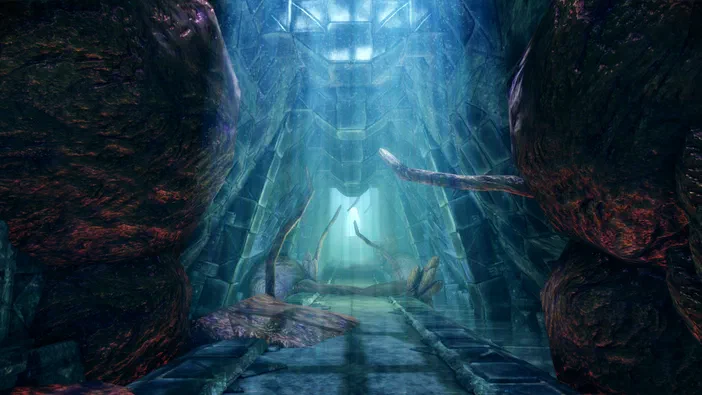 Vue d'un passage aquatique souterrain dans Dragon Age: Origins - Awakening, bordé de rochers massifs et menant vers une arche lumineuse.