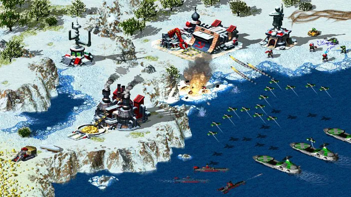 Capture du jeu Command & Conquer: Red Alert™ 2 and Yuri’s Revenge™ montrant des bases militaires sur un terrain enneigé avec de l'artillerie, des avions en formation au-dessus d'une mer bleue.