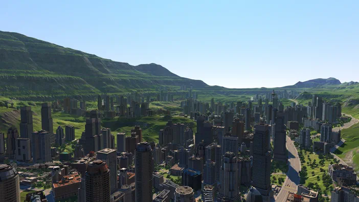 Vue panoramique du jeu Cities XL Platinum présentant une métropole avec d'innombrables gratte-ciels gris éparpillés sur un relief vallonné et verdoyant, bordé par des montagnes sous un ciel dégagé.