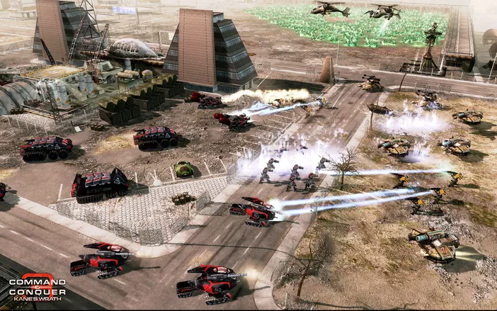 Capture d'écran de Command & Conquer 3: Kane's Wrath montrant un affrontement entre des unités blindées dans une zone industrielle avec le logo du jeu en bas à gauche.