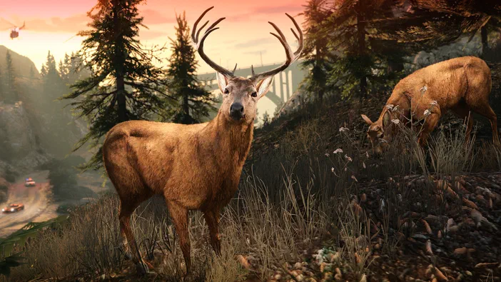 Deux cerfs au premier plan sur un terrain herbeux entouré d'arbres conifères ; des voitures circulent sur une route en contrebas et un hélicoptère survole la scène colorée de Grand Theft Auto V Enhanced.