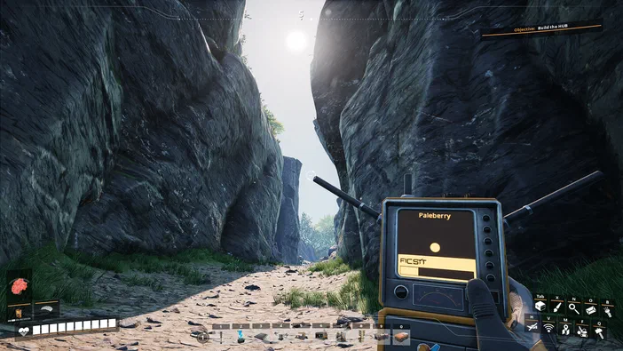 Capture d'écran du jeu vidéo Satisfactory montrant une vue en première personne dans un canyon rocheux avec l'interface utilisateur visible.