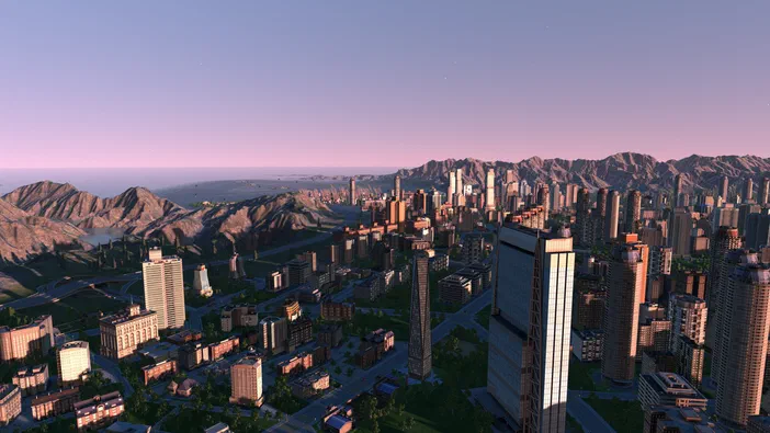 Capture d'écran du jeu Cities XL Platinum montrant une ville dense avec des gratte-ciels au premier plan et des montagnes en arrière-plan sous un ciel crépusculaire.