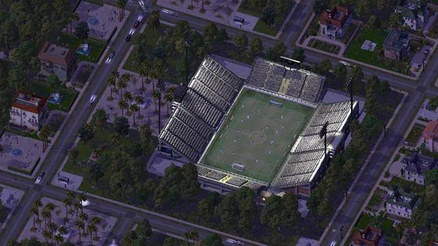 Vue aérienne d'un stade de football vert entouré de tribunes grises dans le jeu SimCity 4 Deluxe