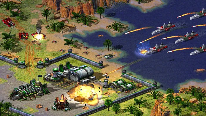 Capture d'écran de Command & Conquer : Red Alert 2 montrant une base militaire en feu sur un rivage tropical avec des navires et des missiles dans la mer.