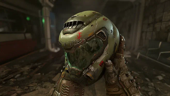Capture d'écran du jeu vidéo DOOM Eternal montrant le personnage principal en armure verte dans un environnement industriel sombre.