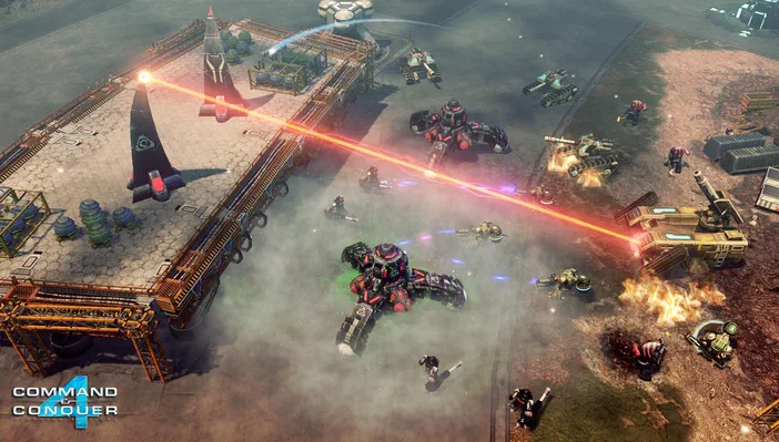 Capture d'écran de Command & Conquer™ 4 Tiberian Twilight montrant une bataille entre des unités et bases ennemies avec des lasers rouges.