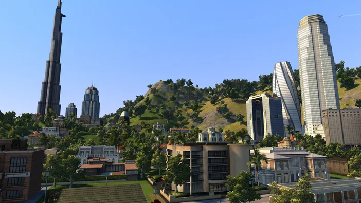 Vue d'une ville simulée dans Cities XL Platinum avec des gratte-ciels et une colline verdoyante.
