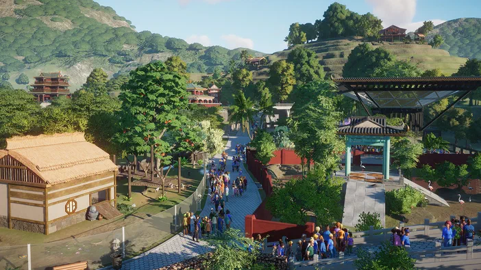 Vue de la ville dans le jeu Planet Zoo avec des bâtiments et une foule d'animaux