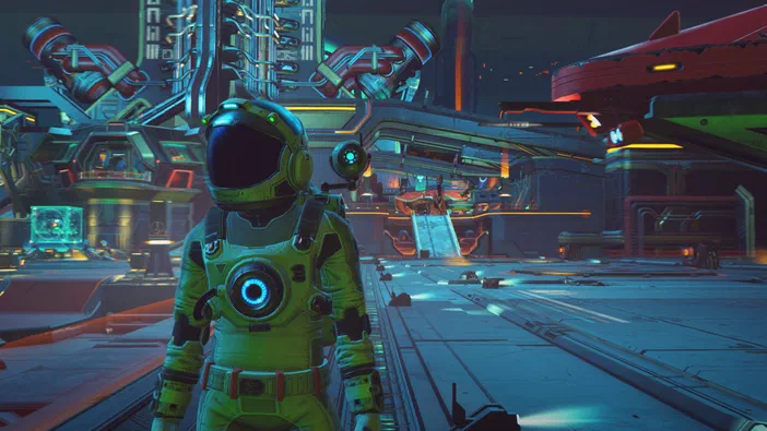 No Man's Sky : un astronaute vert se tient dans une base spatiale futuriste aux couleurs néons.