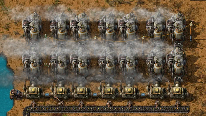 Vue de haut d'une base industrielle complexe dans le jeu Factorio, composée de multiples unités de production et de trains sur des rails.