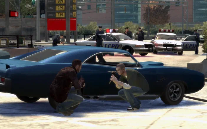 Dans Grand Theft Auto IV, deux personnages se tiennent derrière une voiture bleue alors que des policiers en uniforme observent la scène depuis le fond.