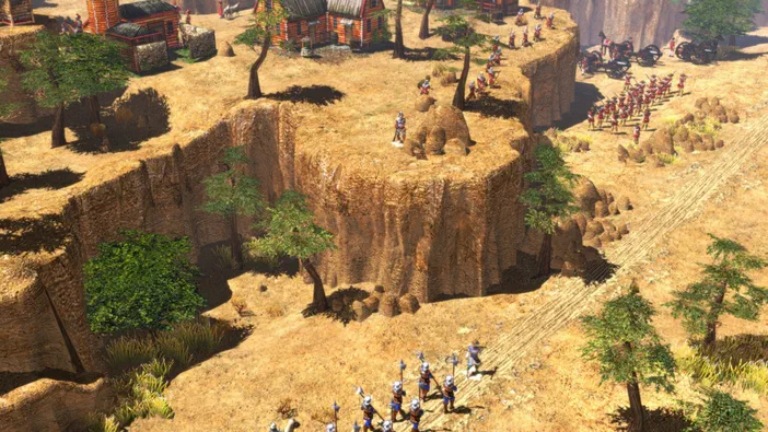 Capture d'écran du jeu vidéo Age of Empires III montrant des troupes et un village dans une vallée.