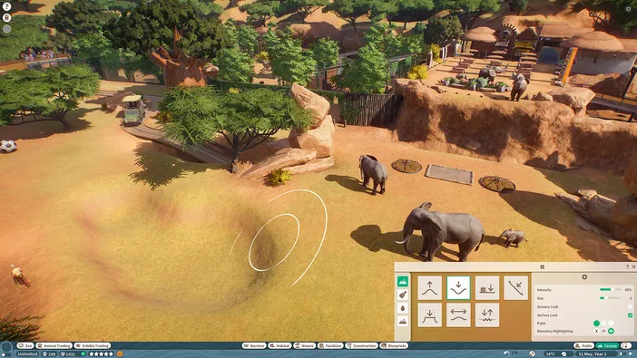 Capture d'écran du jeu Planet Zoo montrant des éléphants dans un enclos avec une interface utilisateur visible.