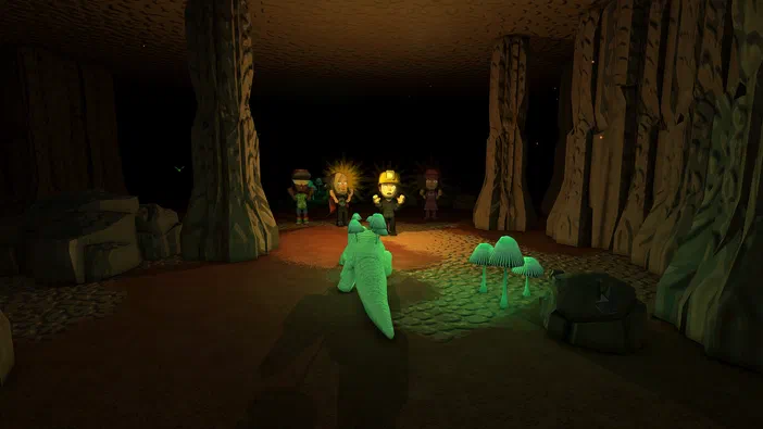 Capture d'écran du jeu vidéo Dinkum montrant un personnage vert dans une grotte avec des autres personnages au loin.