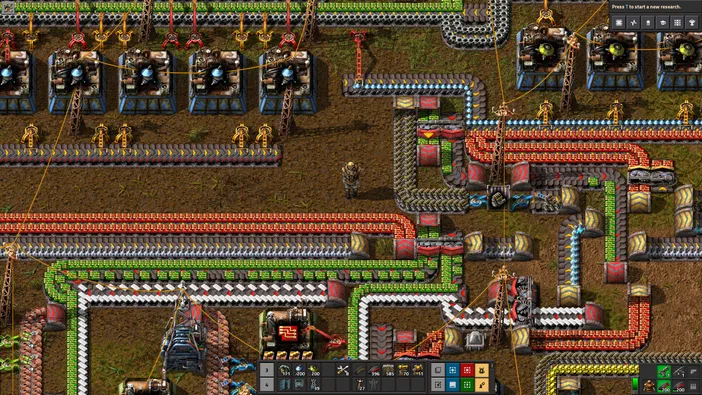 Capture d'écran du jeu de stratégie Factorio montrant une base industrielle complexe avec des convoyeurs et des tours.