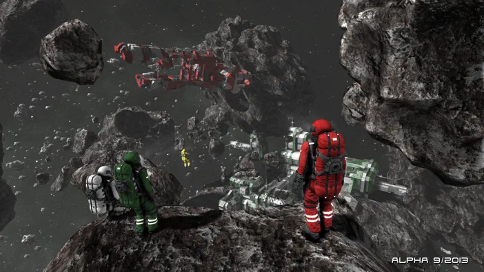 Dans l'espace, des astronautes en combinaison rouge et verte observent une station spatiale construite parmi les astéroïdes dans le jeu Space Engineers.
