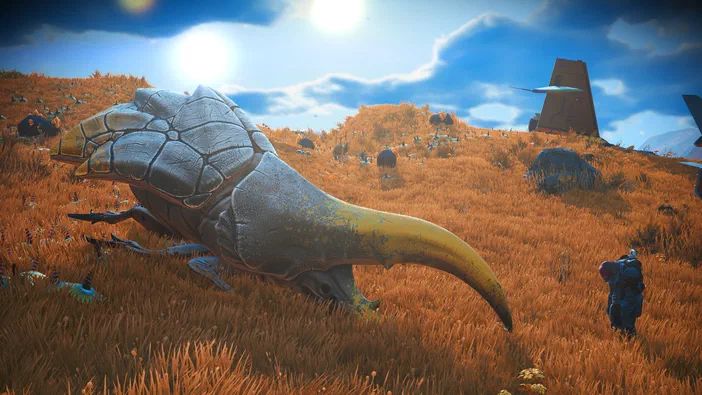 Dans le jeu vidéo No Man's Sky, un explorateur en armure observe une créature ailée imposante sur des collines herbeuses sous un ciel bleu.