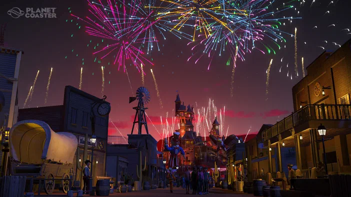 Capture d'écran du jeu Planet Coaster montrant une scène de parc à thème avec des feux d'artifice colorés dans le ciel.