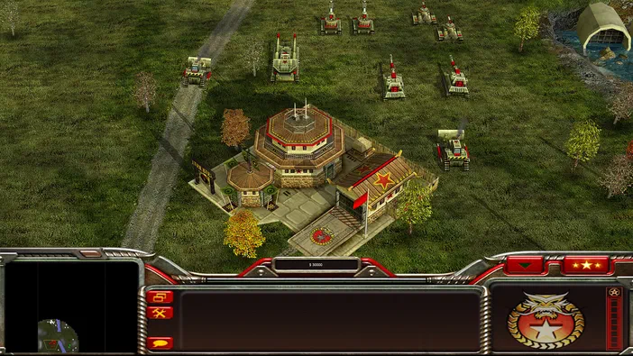 Capture d'écran du jeu de stratégie Command & Conquer™ Generals Zero Hour montrant une base avec des véhicules militaires sur un terrain herbeux.