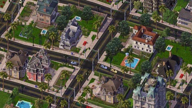 Vue aérienne d'une ville de SimCity avec des maisons colorées, des routes et des piscines.