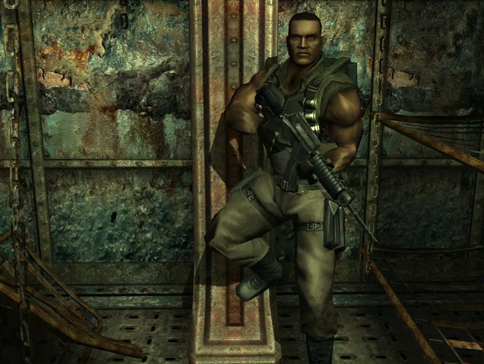 Dans le jeu vidéo Far Cry, un soldat musclé en tenue de combat tient une arme à feu dans un environnement industriel délabré.