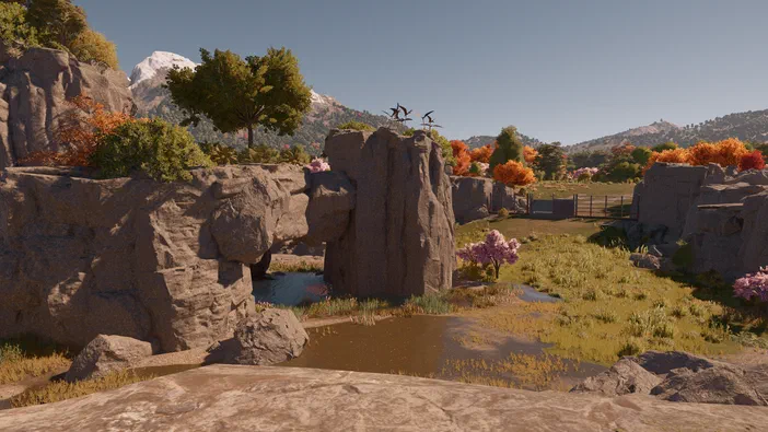 Paysage de Jurassic World Evolution avec des rochers, une rivière et des dinosaures perchés sur un affleurement.