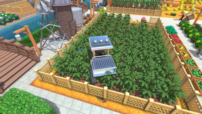 Capture d'écran du jeu vidéo Dinkum montrant un grand jardin potager avec des plants de tomates et une structure technique au centre.