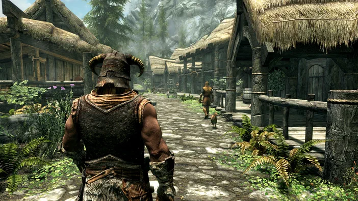 Vue de dos d'un personnage en armure dans le village de Riverwood, The Elder Scrolls V: Skyrim Special Edition