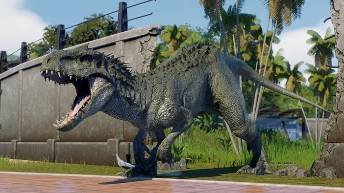 Capture d'écran du jeu Jurassic World Evolution 2 montrant un dinosaure carnivore en pleine action dans une enceinte.