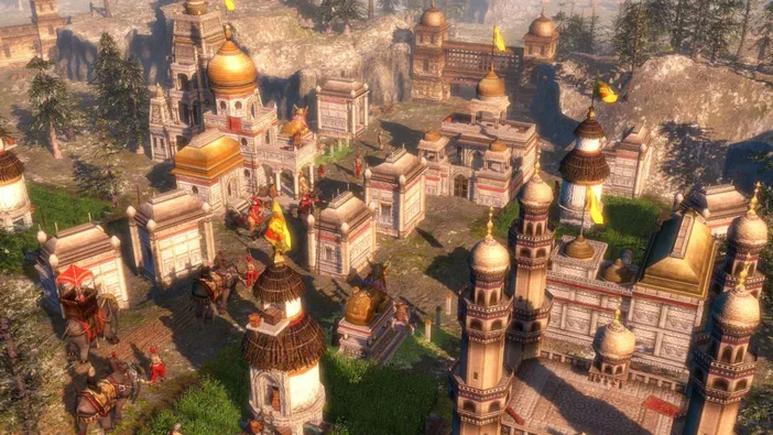 Vue aérienne d'une ville historique dans le jeu vidéo Age of Empires III avec des bâtiments à dômes dorés et des soldats.