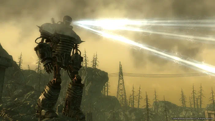 Dans Fallout 3 - Game of the Year Edition, un Power Armor tire des rayons lumineux dans une zone post-apocalyptique avec des arbres morts et des pylônes électriques.