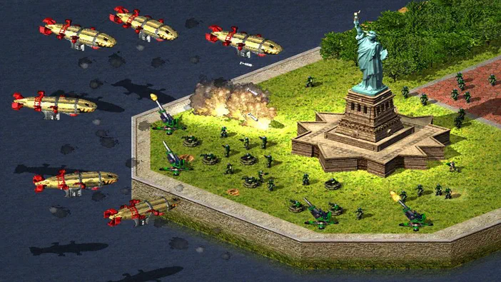 Capture d'écran du jeu vidéo Command & Conquer : Red Alert 2 montrant une base avec la Statue de la Liberté au centre, des canons et des troupes en défense contre un bombardement aérien.