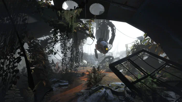 Capture d'écran de Portal 2 montrant une tête de porteuse suspendue dans un environnement industriel envahi par la végétation.