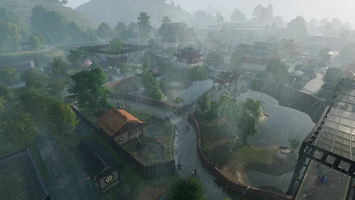 Vue aérienne d'un zoo dans le jeu Planet Zoo sous la pluie avec des bâtiments et des sentiers.