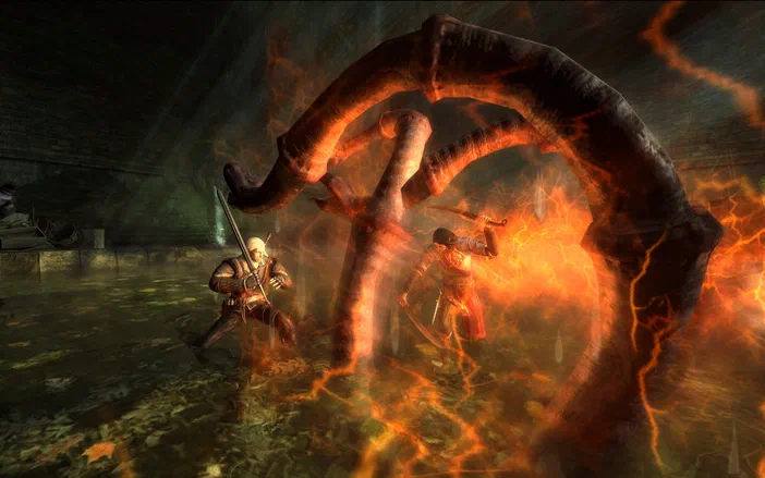 Dans The Witcher: Enhanced Edition, Geralt affronte un monstre géant aux tentacules enflammés dans une grotte sombre.