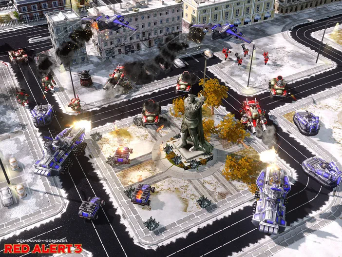 Capture d'écran du jeu vidéo Command & Conquer Red Alert 3 montrant une bataille urbaine avec des chars et des soldats dans un carrefour enneigé.