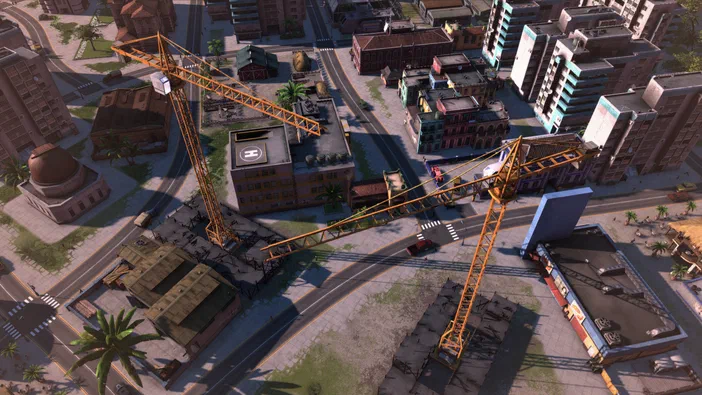 Vue aérienne d'une ville en construction dans le jeu Tropico 5 avec des grues jaunes et divers bâtiments.