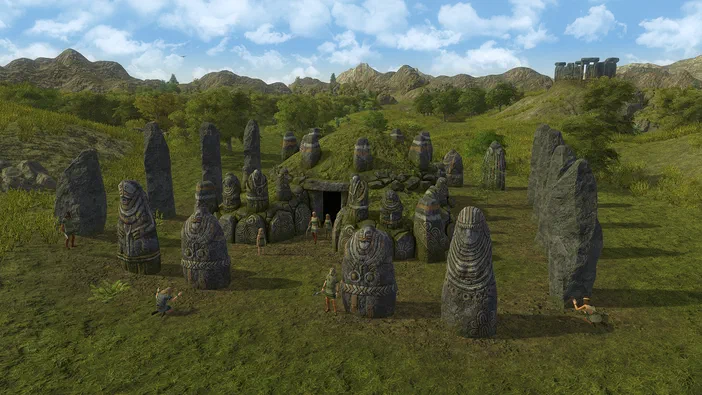 Capture d'écran du jeu vidéo Dawn of Man montrant un site archéologique avec des mégalithes et des statues dans une plaine verdoyante.