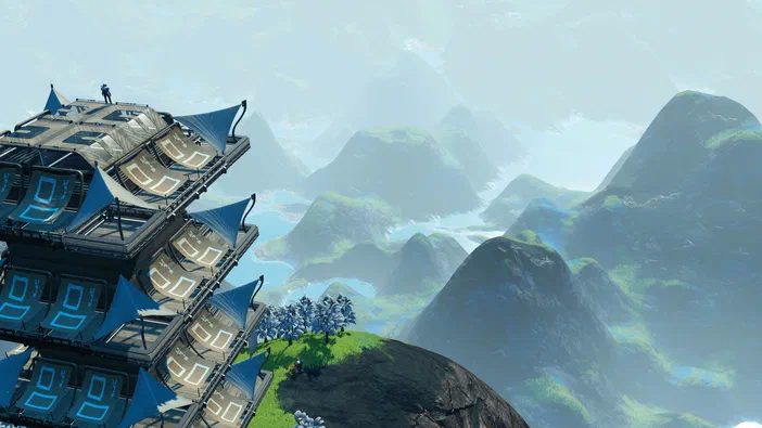 Capture d'écran du jeu vidéo No Man's Sky montrant une structure futuriste bleue perchée sur un promontoire rocheux avec des montagnes verdoyantes en arrière-plan.